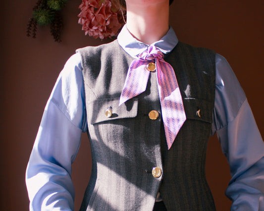 Model wearing a grey pinstriped vest with the purple Wild Overture Silk Twilly Scarf by The Line Atelier