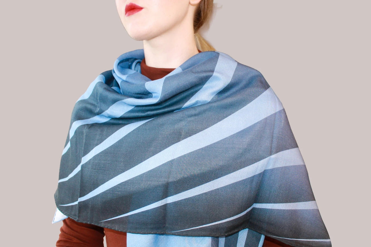 Model wearing a blue wool and silk scarf by The Line Atelier
