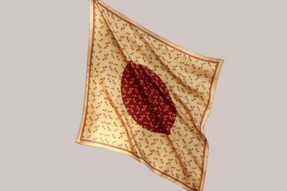 Golden 60cm silk scarf with a auburn dragonfly design on a beige background