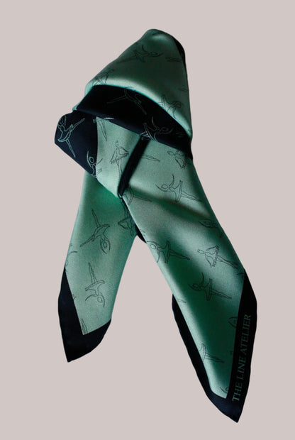 Green and black patterned silkscarf on a white background