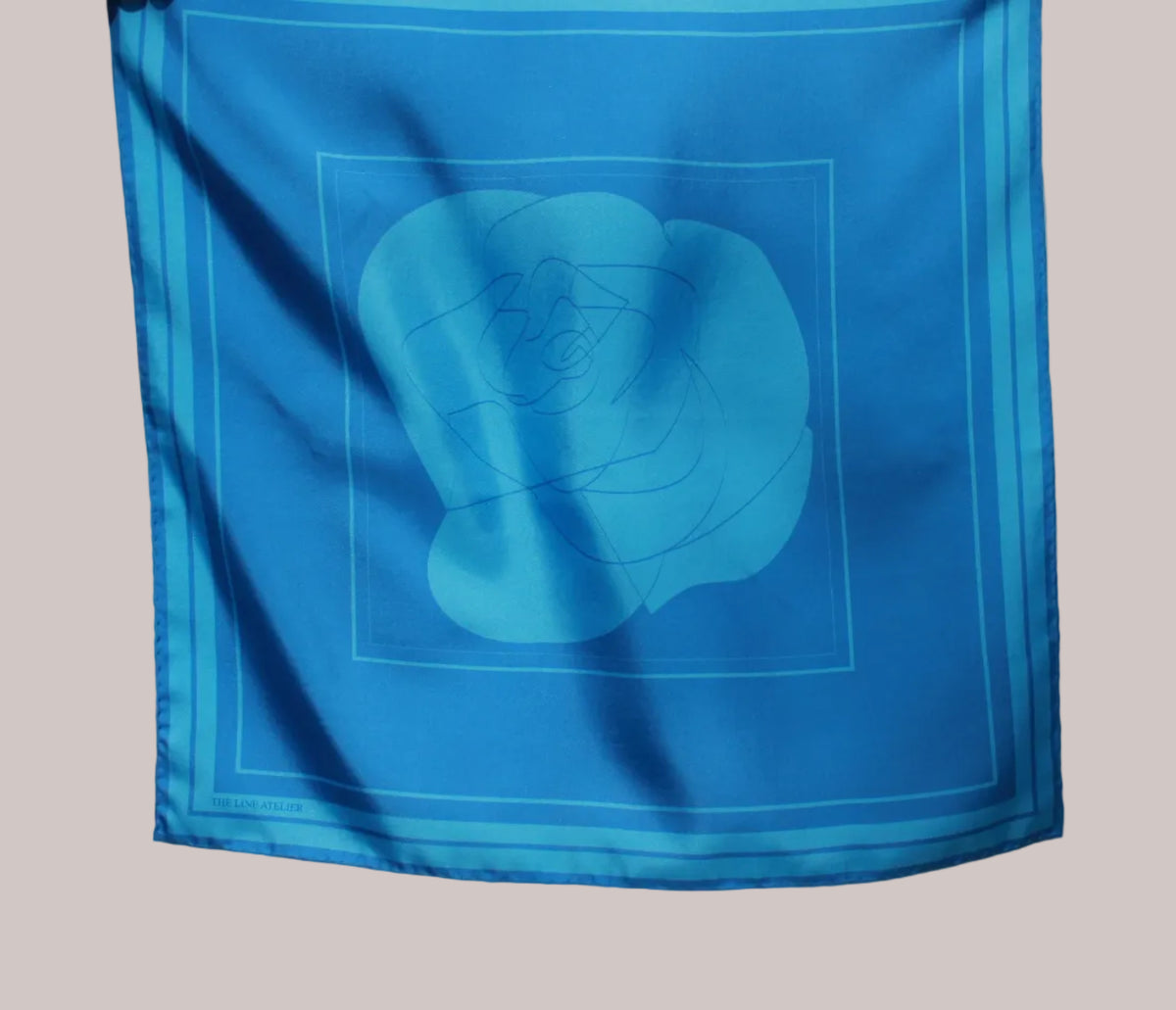 60 x 60 cm sized silk scarf, Midnight Sister, in deep cerulean silk with a large abstract rose motif, hand rolled edges, by The Line Atelier